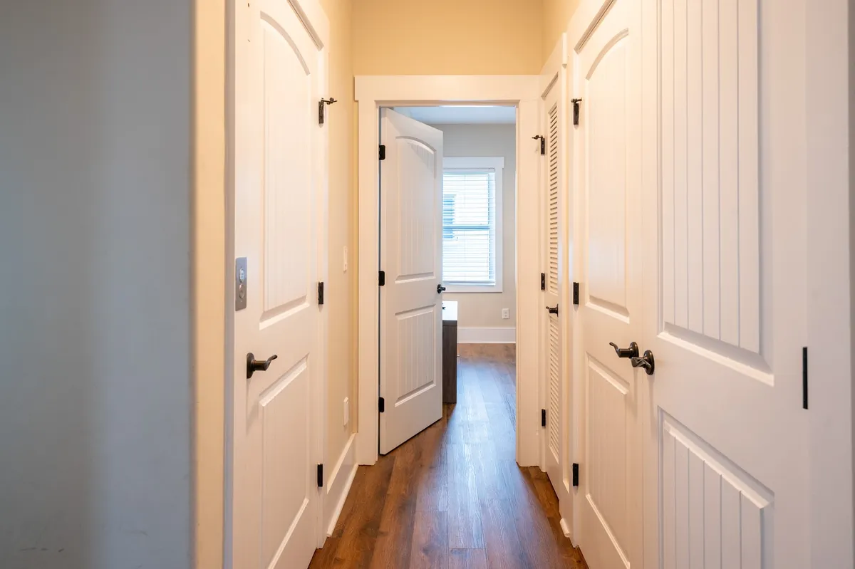 Bright doorways and sunlit flooring create a sense of movement through the home, evoking the feeling of exploring or returning from an outdoor adventure. The natural light and open doors hint at a connection between inside and outside.